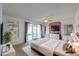 Staged main bedroom with a ceiling fan, sliding glass doors, and wall decor at 4506 E Arapahoe St, Phoenix, AZ 85044