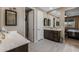 This lovely bathroom provides a vanity with double sinks, modern floors, and ensuite access to the bedroom at 4588 W Suncup Dr, San Tan Valley, AZ 85144