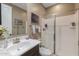 This cozy bathroom features a vanity with sink, mirror, and tiled shower at 4588 W Suncup Dr, San Tan Valley, AZ 85144