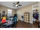 This bedroom features a ceiling fan, closet, and large window for natural light at 4588 W Suncup Dr, San Tan Valley, AZ 85144