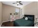 This neutral toned bedroom provides a large window, ceiling fan, and closet space at 4588 W Suncup Dr, San Tan Valley, AZ 85144