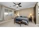 This bedroom features neutral walls, large window, ceiling fan, and a decorative sliding barn door at 4588 W Suncup Dr, San Tan Valley, AZ 85144