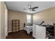 Cozy bedroom with a ceiling fan, wood-look floors, natural light, and tan walls at 4588 W Suncup Dr, San Tan Valley, AZ 85144