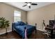 This bedroom features neutral walls, dark hardwood floors, ceiling fan, and a large sunny window at 4588 W Suncup Dr, San Tan Valley, AZ 85144