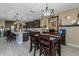 Dining area adjacent to kitchen, with modern chandelier and views of the kitchen and center island at 4588 W Suncup Dr, San Tan Valley, AZ 85144