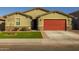 Charming single-story home featuring a manicured lawn and a red two-car garage at 4588 W Suncup Dr, San Tan Valley, AZ 85144