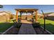 Backyard gazebo with a brick paver base and walkway in a landscaped backyard at 4588 W Suncup Dr, San Tan Valley, AZ 85144