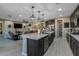 Bright, open kitchen connects to living area, featuring stainless appliances and center island at 4588 W Suncup Dr, San Tan Valley, AZ 85144