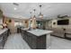 Open kitchen layout with island, seamless flow to dining and living areas, perfect for entertaining at 4588 W Suncup Dr, San Tan Valley, AZ 85144