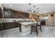 Stylish kitchen with center island, modern lighting, and easy access to adjacent dining area at 4588 W Suncup Dr, San Tan Valley, AZ 85144