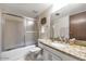 Bathroom featuring a shower-tub combination and granite vanity with decorative fixtures at 4620 N 68Th St # 116, Scottsdale, AZ 85251