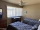 Bedroom featuring two beds, a desk, and a large window with bright natural light at 4620 N 68Th St # 116, Scottsdale, AZ 85251