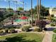 A community pool with manicured landscaping, tall trees and plenty of lounge chairs at 4620 N 68Th St # 116, Scottsdale, AZ 85251