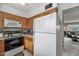 Efficient kitchen with white refrigerator and wood cabinets connecting to the living room at 4620 N 68Th St # 116, Scottsdale, AZ 85251