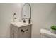 Bathroom with gray vanity, arched mirror and white walls at 4821 S 12Th St, Phoenix, AZ 85040