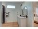 Bright bathroom featuring a double vanity with elegant framed mirrors and wood-look tile floors at 4821 S 12Th St, Phoenix, AZ 85040