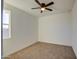 Empty room with neutral carpet, ceiling fan, and a window providing natural light at 4821 S 12Th St, Phoenix, AZ 85040