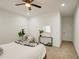 Minimalist bedroom showcasing a ceiling fan and a cozy seating area by the bedside at 4821 S 12Th St, Phoenix, AZ 85040