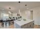 Bright, open-concept kitchen with large island, modern lighting, and a view into the dining and living area at 4821 S 12Th St, Phoenix, AZ 85040