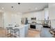 Modern kitchen with white cabinets, stainless steel appliances, and a center island with seating at 4821 S 12Th St, Phoenix, AZ 85040