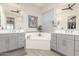 Bright bathroom featuring dual vanities, soaking tub, and a walk-in closet at 4887 N 184Th Ln, Goodyear, AZ 85395