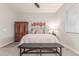 Bright primary bedroom with decorative art, a bench, and large window at 4887 N 184Th Ln, Goodyear, AZ 85395