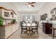 Open dining area with a neutral color palette, hardwood flooring, and tray ceiling at 4887 N 184Th Ln, Goodyear, AZ 85395