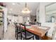 Open dining area leading to kitchen and living spaces, features stylish lighting and wood floors at 4887 N 184Th Ln, Goodyear, AZ 85395