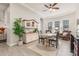 Bright dining area with tray ceiling, natural light, modern ceiling fan, and hardwood floors at 4887 N 184Th Ln, Goodyear, AZ 85395