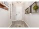 Bright foyer features wood-look floors, coat rack, decor, and front door with an electronic lock at 4887 N 184Th Ln, Goodyear, AZ 85395