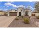 Attractive single-story home with a well-manicured desert landscape and attached two-car garage at 4887 N 184Th Ln, Goodyear, AZ 85395