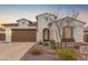 Charming single-story home featuring a well-maintained lawn, desert landscaping, and a two-car garage at 4887 N 184Th Ln, Goodyear, AZ 85395