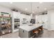 Spacious kitchen with white cabinets, a large center island, pendant lighting, and modern appliances at 4887 N 184Th Ln, Goodyear, AZ 85395