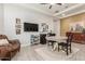 Open-concept living area with hardwood floors, television, recessed lighting, and a stylish rug at 4887 N 184Th Ln, Goodyear, AZ 85395