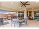 Covered patio with outdoor dining, grill, and sliding glass doors for indoor-outdoor living at 4887 N 184Th Ln, Goodyear, AZ 85395