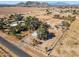 An aerial view of a spacious property with mature trees and mountain views in the distance at 50880 W Val Vista Rd, Maricopa, AZ 85139