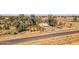 An aerial view displays a single-story home in a gated property surrounded by trees and open land at 50880 W Val Vista Rd, Maricopa, AZ 85139