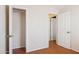 Bedroom with wood floors, closet and view to another room at 50880 W Val Vista Rd, Maricopa, AZ 85139