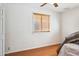 Bright bedroom featuring wood flooring, a ceiling fan, and a window with wooden blinds at 50880 W Val Vista Rd, Maricopa, AZ 85139