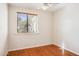 This bedroom boasts wood floors and a window with wooden blinds at 50880 W Val Vista Rd, Maricopa, AZ 85139