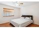 Bedroom featuring wood flooring, a bed, a ceiling fan, and a window with wooden blinds at 50880 W Val Vista Rd, Maricopa, AZ 85139