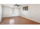 Bright bedroom featuring wood-look flooring, a ceiling fan, and a window at 50880 W Val Vista Rd, Maricopa, AZ 85139