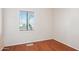 Bedroom featuring wood flooring and a window with blinds at 50880 W Val Vista Rd, Maricopa, AZ 85139