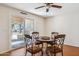 Light-filled dining room with wood floors, chandelier, table with four chairs and sliding door to back yard at 50880 W Val Vista Rd, Maricopa, AZ 85139