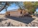 Charming home with a neutral stucco exterior and a gravel area perfect for outdoor entertaining at 50880 W Val Vista Rd, Maricopa, AZ 85139