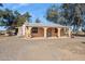 Single-story home featuring stucco walls, a covered porch with arched columns, and gravel landscaping at 50880 W Val Vista Rd, Maricopa, AZ 85139