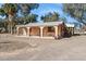 Single-story home with stucco walls, a covered porch with arched columns, and gravel landscaping at 50880 W Val Vista Rd, Maricopa, AZ 85139