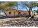 The exterior of this home shows a stucco wall, small windows and natural desert landscaping at 50880 W Val Vista Rd, Maricopa, AZ 85139