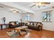 Bright living room with hardwood floors, neutral walls, ceiling fans, and comfortable couches at 50880 W Val Vista Rd, Maricopa, AZ 85139