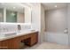 Modern bathroom features double sinks, sleek fixtures, and a soaking tub with white tile surround at 5455 E Lincoln Dr # 2009, Paradise Valley, AZ 85253